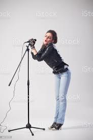 female-rock-singer-holding-microphone-on-stand-picture-id693726702.jpg